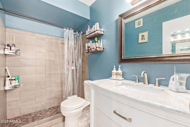 bathroom featuring vanity, toilet, and a shower with shower curtain