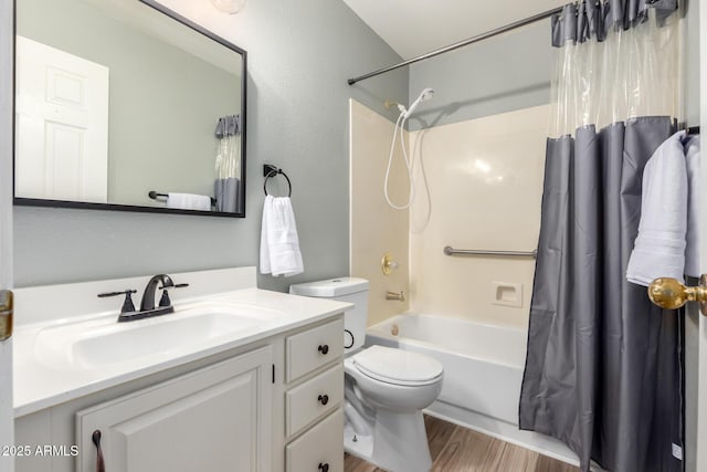 bathroom featuring toilet, shower / bath combo, wood finished floors, and vanity