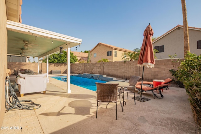 view of swimming pool with a patio area, a fenced backyard, ceiling fan, and a fenced in pool