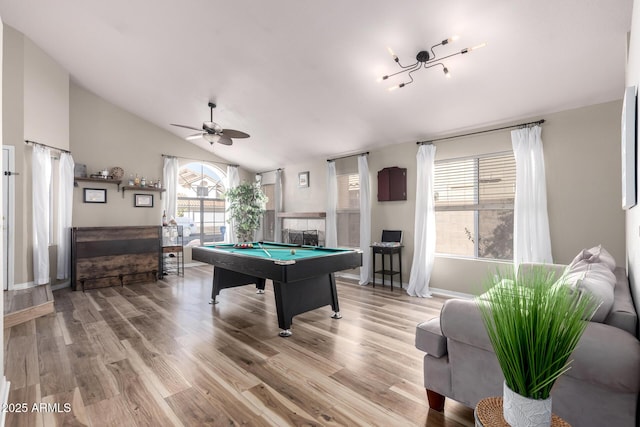 game room featuring lofted ceiling, billiards, a tiled fireplace, and wood finished floors