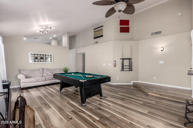 playroom featuring high vaulted ceiling, visible vents, baseboards, and wood finished floors