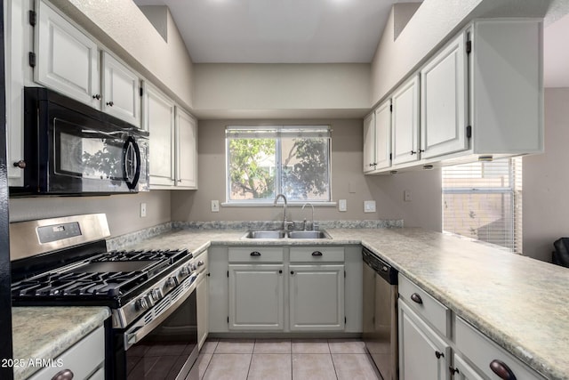 kitchen featuring stainless steel appliances, a sink, light countertops, and white cabinets