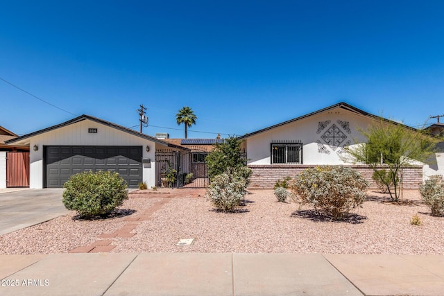 554 N Sunset Dr, Chandler, AZ 85225 - ranch-style home with a fenced front yard, driveway, a garage, a gate, and stucco siding