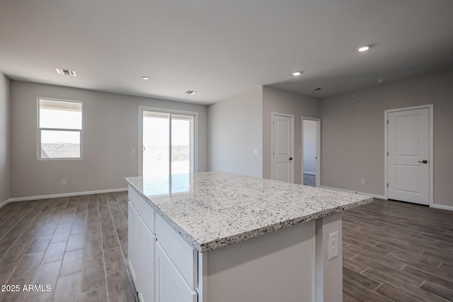 19320 N Diego Way, Maricopa, AZ 85138 - kitchen featuring dark wood-type flooring, plenty of natural light, a center island, baseboards, and recessed lighting
