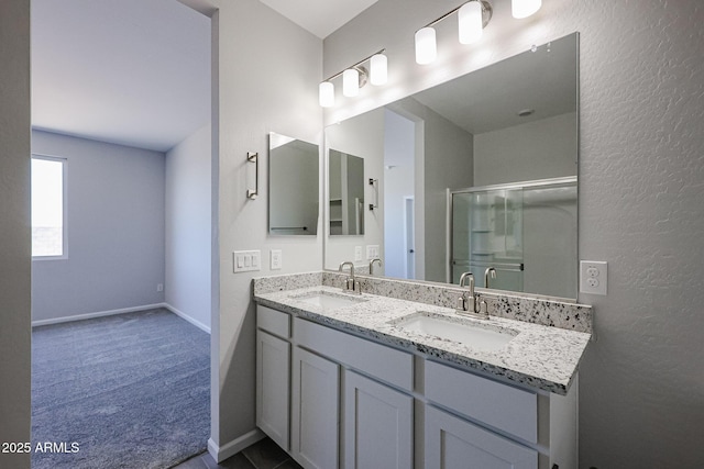 19320 N Diego Way, Maricopa, AZ 85138 - full bath featuring double vanity, a shower stall, baseboards, and a textured wall