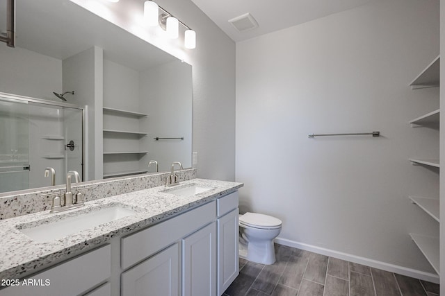 19320 N Diego Way, Maricopa, AZ 85138 - full bathroom featuring a shower stall, double vanity, toilet, wood finished floors, and baseboards