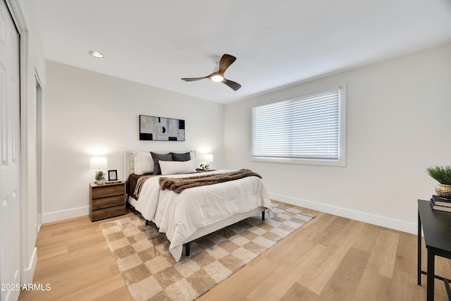 bedroom with baseboards, recessed lighting, ceiling fan, and light wood-style floors