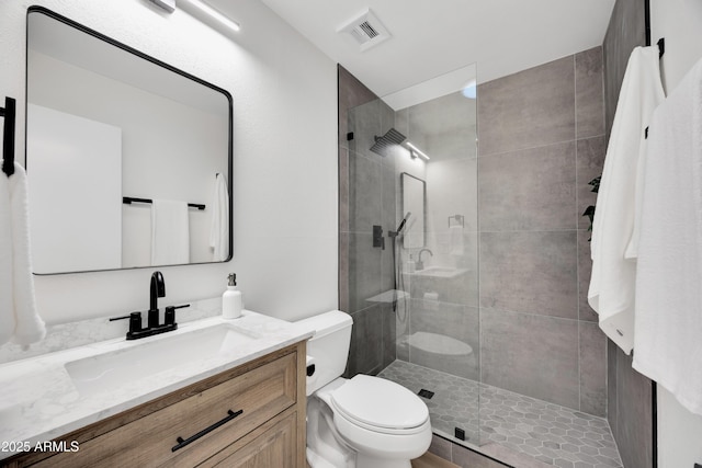 full bath with visible vents, toilet, vanity, and walk in shower