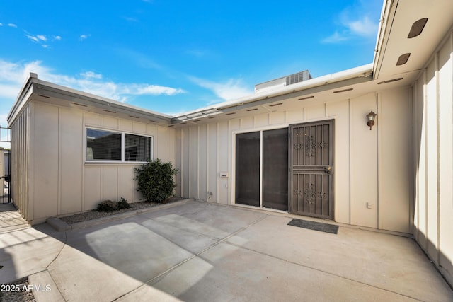 back of property featuring board and batten siding and a patio area
