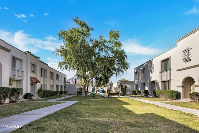 view of community featuring a residential view and a yard