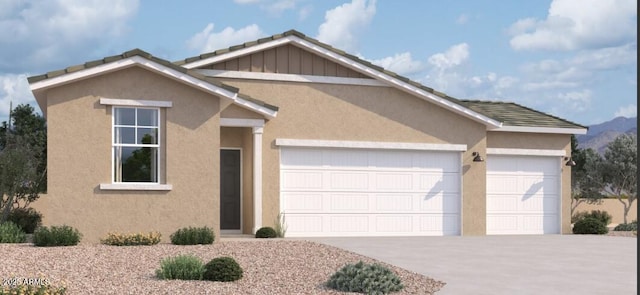 view of front of house with a mountain view, stucco siding, driveway, and a garage
