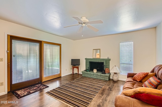 8355 E Via De Los Libros, Scottsdale, AZ 85258 - living room featuring wood finished floors, a fireplace, and a ceiling fan