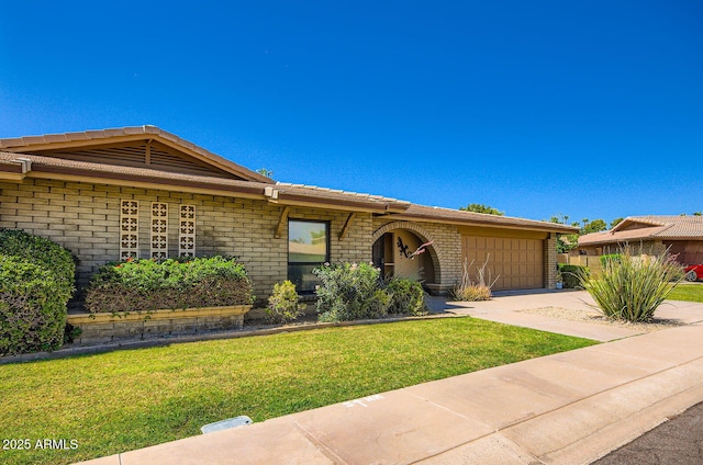 8355 E Via De Los Libros, Scottsdale, AZ 85258 - ranch-style home featuring brick siding, a front lawn, driveway, and a garage