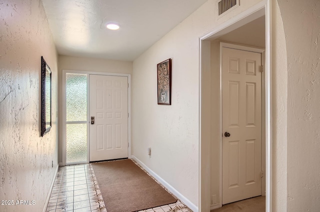 8355 E Via De Los Libros, Scottsdale, AZ 85258 - entryway with a textured wall, light carpet, and light tile patterned flooring