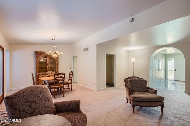8355 E Via De Los Libros, Scottsdale, AZ 85258 - living area featuring light carpet, arched walkways, and a chandelier