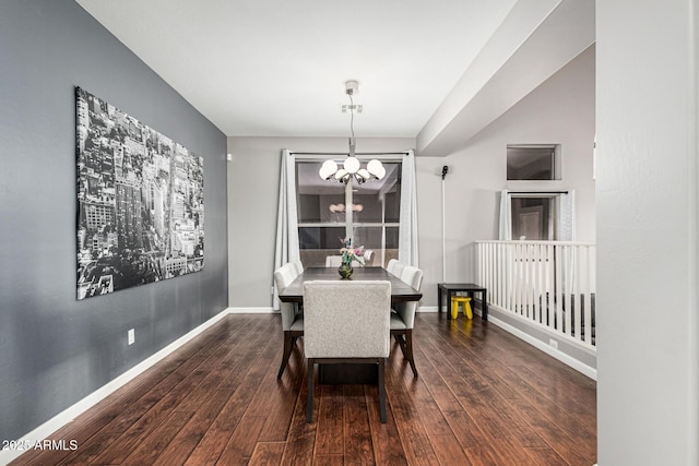 dining area with dark wood-type flooring and a chandelier