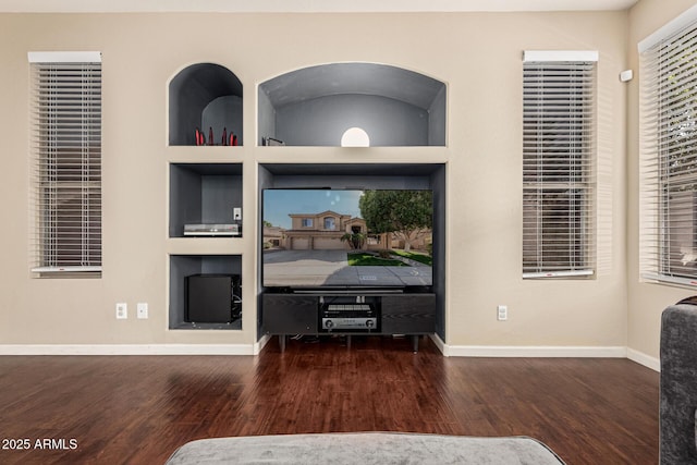 interior space with dark hardwood / wood-style floors and built in shelves