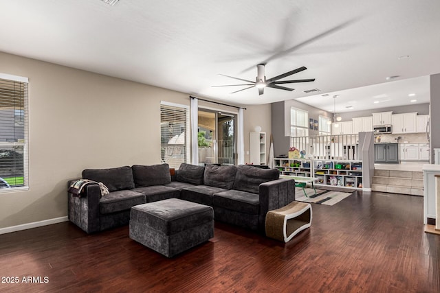 living room with dark wood-type flooring and ceiling fan