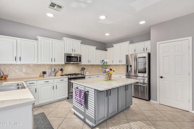 kitchen featuring white cabinetry, appliances with stainless steel finishes, and sink