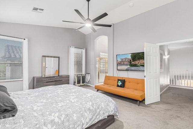 carpeted bedroom with ceiling fan and vaulted ceiling