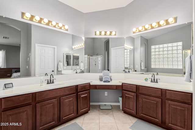 bathroom featuring vanity, vaulted ceiling, tile patterned floors, and walk in shower