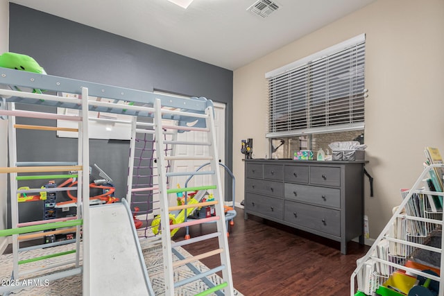 bedroom with dark hardwood / wood-style flooring