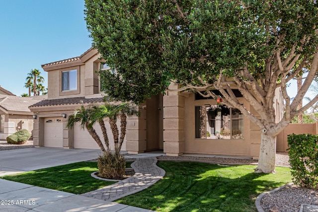 view of front of property featuring a garage and a front lawn