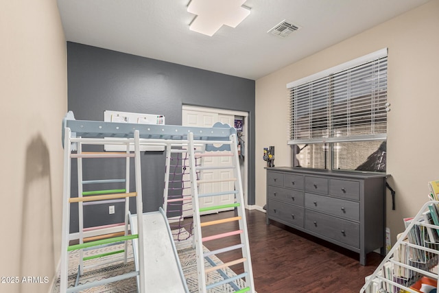 bedroom with dark hardwood / wood-style floors