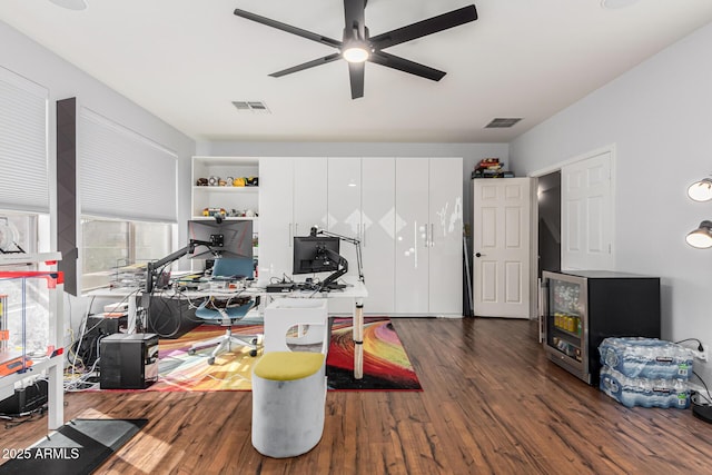 home office featuring dark hardwood / wood-style flooring and ceiling fan