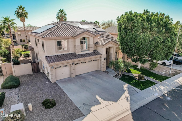 view of front of home with a garage and solar panels