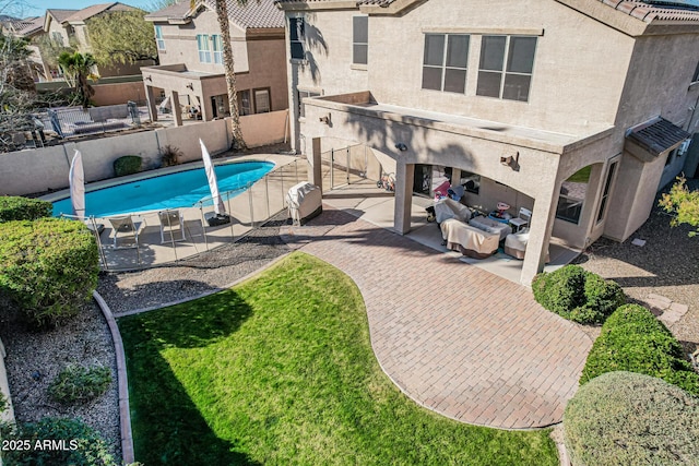 view of swimming pool featuring a patio area and an outdoor living space with a fireplace