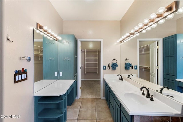 bathroom with dual sinks, tile flooring, and vanity with extensive cabinet space