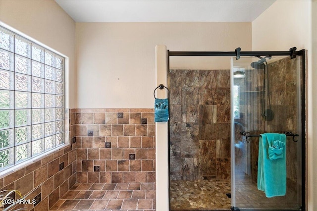 bathroom featuring a shower with shower door