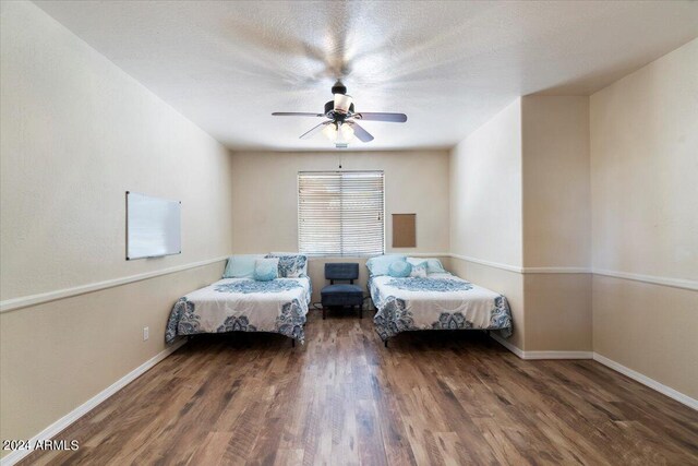 bedroom with ceiling fan and wood-type flooring