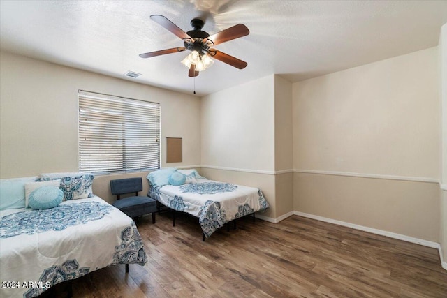 bedroom with wood-type flooring and ceiling fan