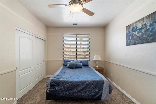 bedroom with carpet, ceiling fan, and a closet