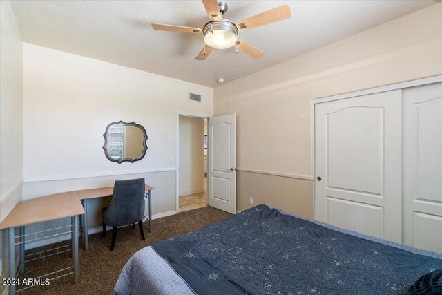 carpeted bedroom with a closet and ceiling fan