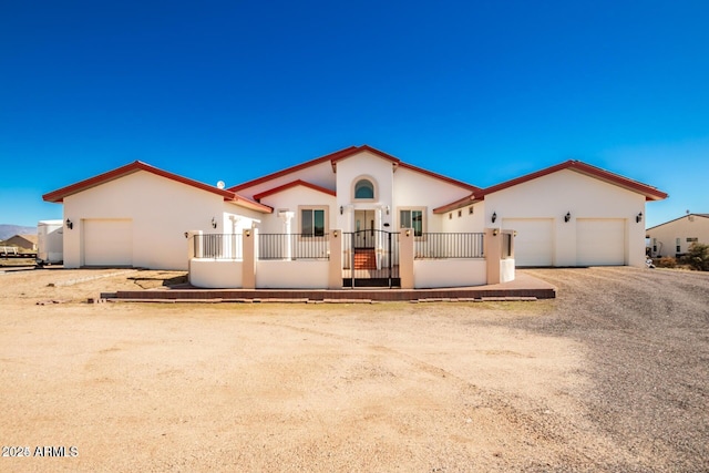 30124 N 174th St, Rio Verde, AZ 85263 - mediterranean / spanish-style house featuring a garage, stucco siding, dirt driveway, and a fenced front yard