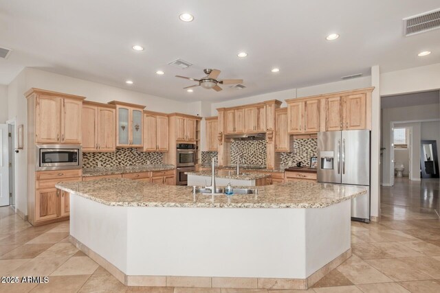 30124 N 174th St, Rio Verde, AZ 85263 - kitchen featuring appliances with stainless steel finishes, a sink, a spacious island, tasteful backsplash, and recessed lighting