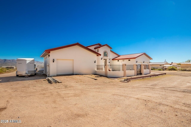 30124 N 174th St, Rio Verde, AZ 85263 - view of front of house featuring an attached garage, stucco siding, and dirt driveway