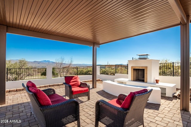 30124 N 174th St, Rio Verde, AZ 85263 - view of patio / terrace with a mountain view, an outdoor living space with a fireplace, and fence