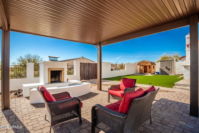 30124 N 174th St, Rio Verde, AZ 85263 - view of patio / terrace with fence, an outbuilding, and an outdoor living space with a fireplace