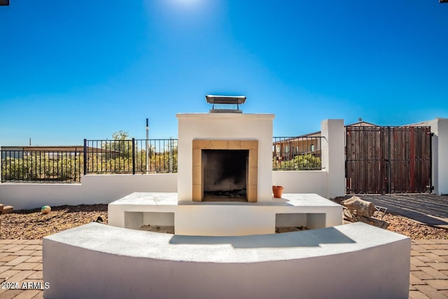 30124 N 174th St, Rio Verde, AZ 85263 - view of patio / terrace with a tiled fireplace and fence