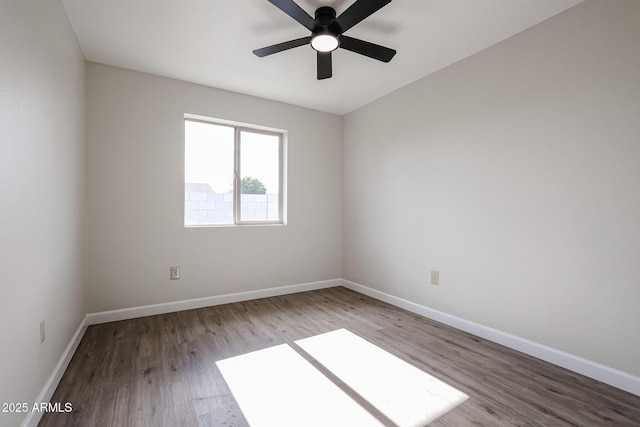 empty room with ceiling fan and wood-type flooring