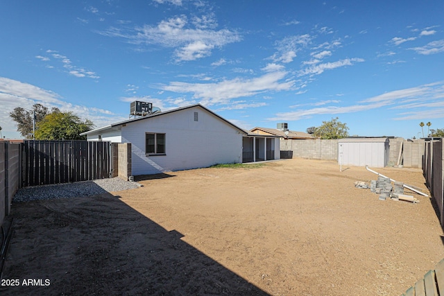 back of house featuring central AC unit