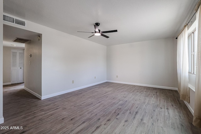 unfurnished room with ceiling fan and wood-type flooring