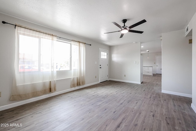 spare room with ceiling fan and light hardwood / wood-style flooring