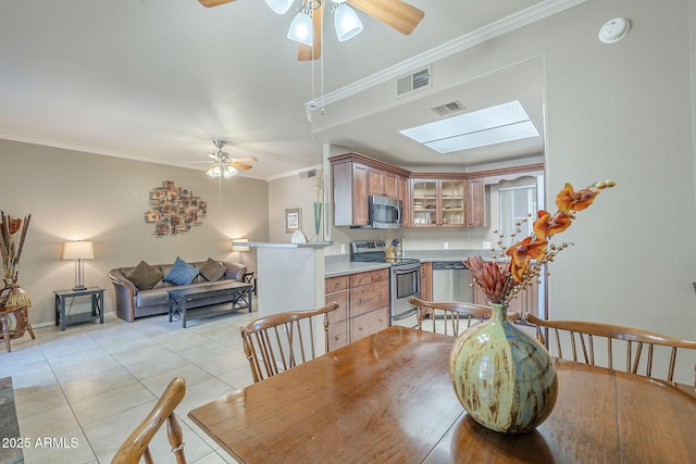 dining space featuring visible vents, a ceiling fan, and ornamental molding