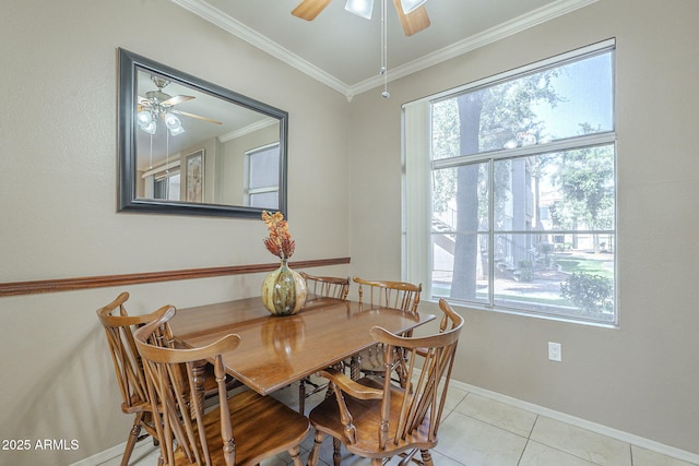 dining room with crown molding, a ceiling fan, baseboards, and light tile patterned flooring