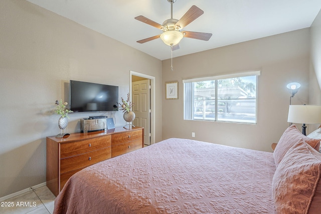 tiled bedroom featuring baseboards and ceiling fan